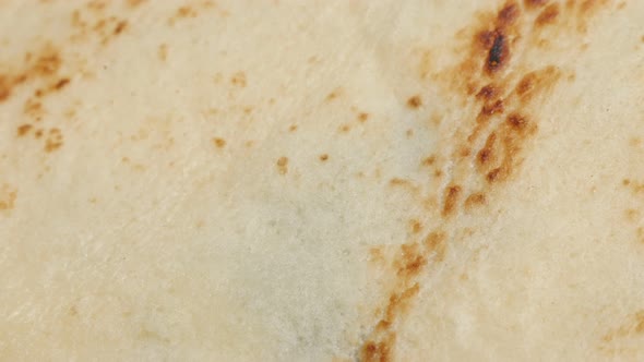 Texture of pancake after being fried slow tilt close-up 4K 2160p 30fps UltraHD footage - Confection 