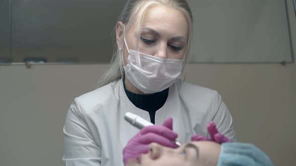 Beauty Salon Cosmetologist in Sterile Gloves Applies Make-up