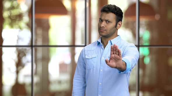 Young Brownskinned Man Showing Stop Gesture