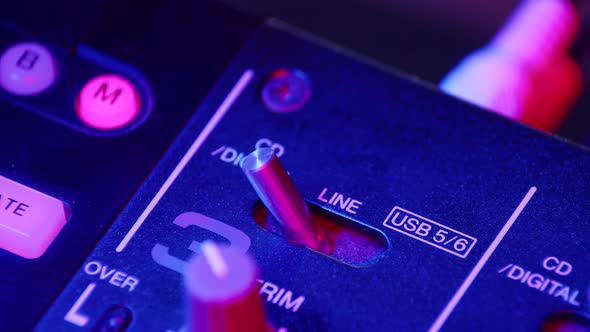 Sound Engineer Switches Toggle Switch on Mixing Console Closeup