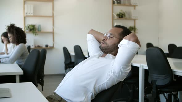 Tired Worker Stretching in Chair the Returning Back To Laptop