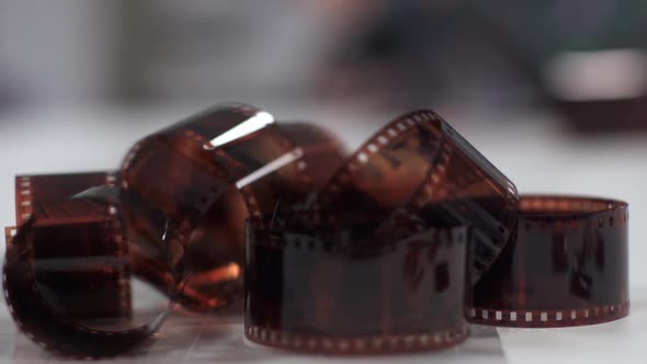 Photographic film negative on a table - Slowmotion