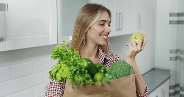 Woman Holding Bag with Green Vegetables
