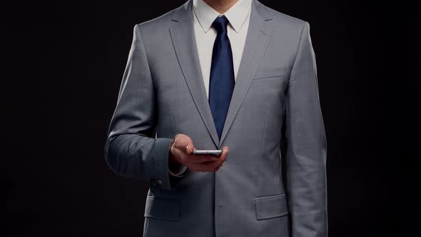 Studio portrait of successful and smart businessman in suit and tie.