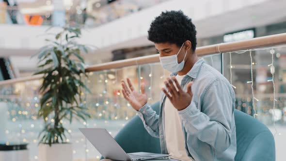 African American Man in Face Medical Mask Office Company Workplace Video Call with Laptop Covid