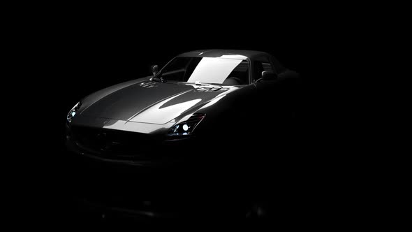 The silhouette of the car slowly emerges from the darkness.