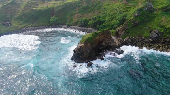 Aerial panorama small bay and rock hit by ocean wave on Java coast Indonesia