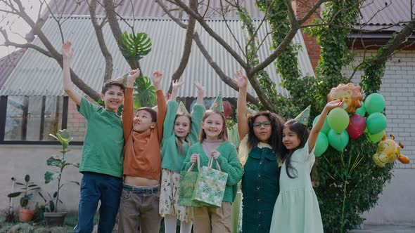 Multinational Children Jumping and Laughing at the Party Looking at the Camera