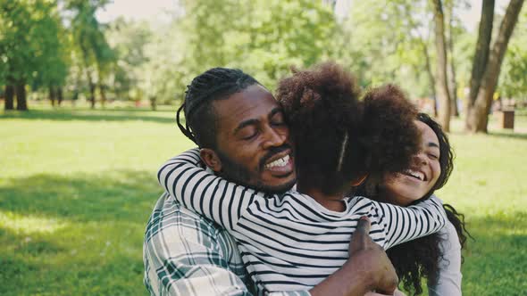 Portrait of a Father and Daughter Having Fun in the Park