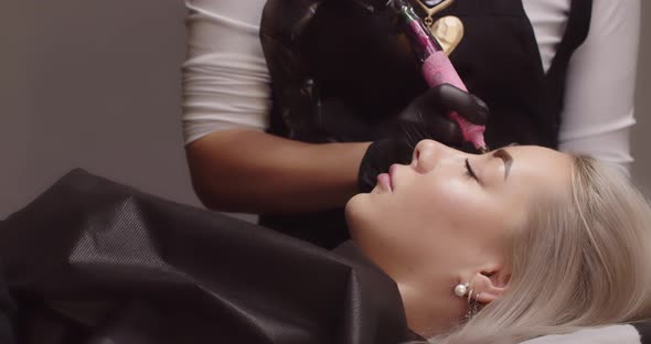 Attractive Girl In A Beauty Salon Makes Permanent Eyebrow Makeup