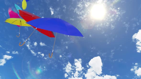 Multicolored Umbrellas Flying High to the Sky Against the Sun with the Wind