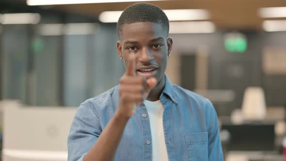 Young African American Man Pointing at the Camera and Inviting