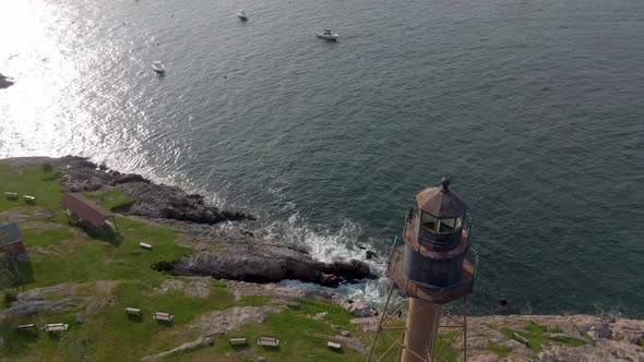 View of the Marblehead Lighthouse with boats in the foreground located in Marblehead, Massachusetts