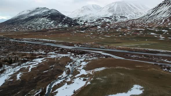 Highlands of Iceland at Autumn. Aerial View of Snowcapped Volcanic Hills, Valley With River, Drone S