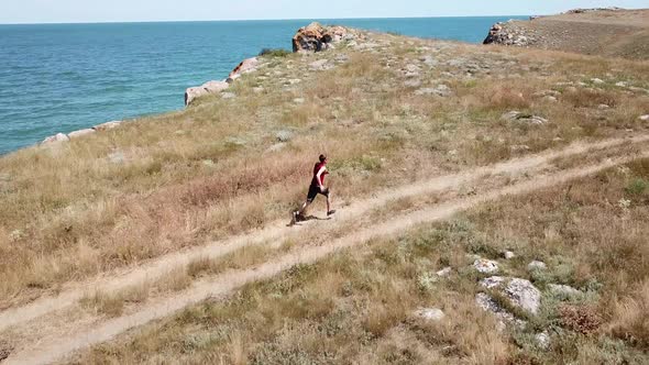 Aerial view. Man is running along general's beaches, Autumn in Crimea