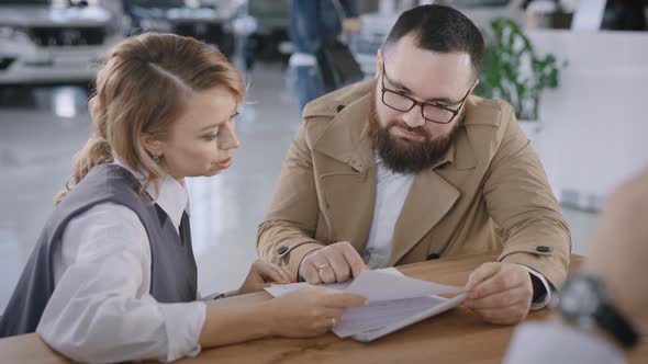 A Married Couple Buys a New Car in a Car Dealership