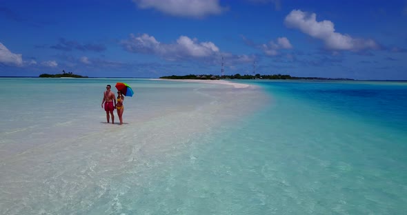 Young man and woman in love dating on vacation enjoy luxury on beach on summer white sandy 4K backgr