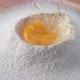 Egg falls on a pile of flour. Slow Motion. - VideoHive Item for Sale