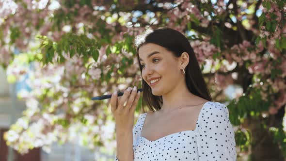 Girl Using Smart Phone Voice Recognition Dictates Thoughts Voice Dialing Message Outdoor