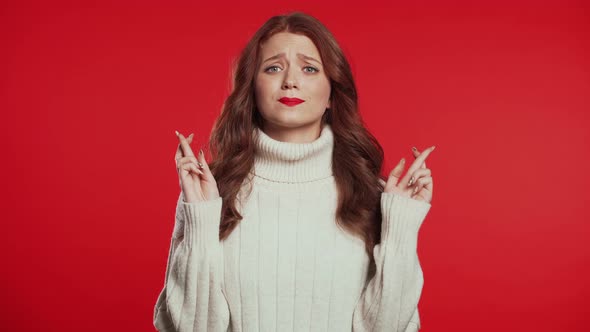 Cute Young Girl with Beautiful Hairstyle Praying Over Red Background