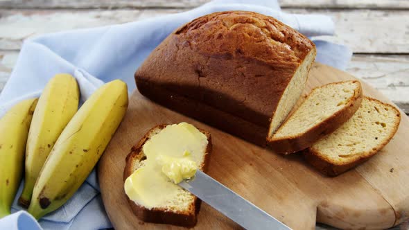 Butter spread on bread slice and bananas