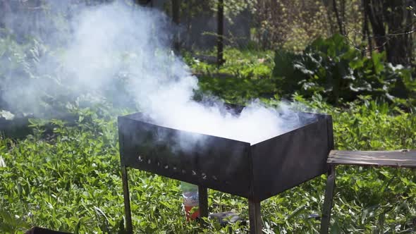 Man Throw Firewood Into Brazier