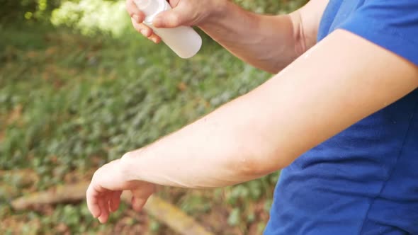 Man Treats the Skin with a Spray From Insects Mosquitoes Ticks Fleas