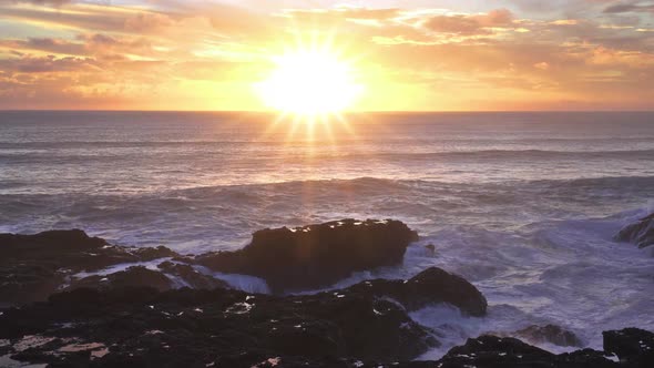Colorful Sunrise Sky over Rocky Ocean Coast Waves
