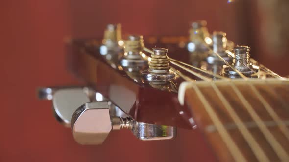Close Up of Tuning Peg on Acoustic Guitar Headstock