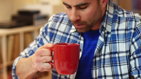 Man using mobile phone while having breakfast