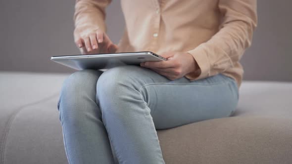 Girl Choosing Meal In Restaurant And Ordering Online Delivery Using Tablet