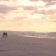 Wide Angle of a Two Young Female Tourist's Silhouettes Walking on the Beach During a Wonderful - VideoHive Item for Sale
