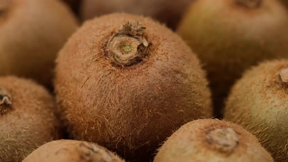 whole kiwi fruit rotating, close up