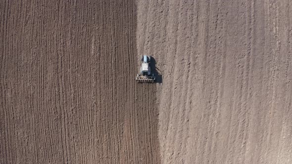 Aerial View of a Tractor That Plows the Land for Sowing