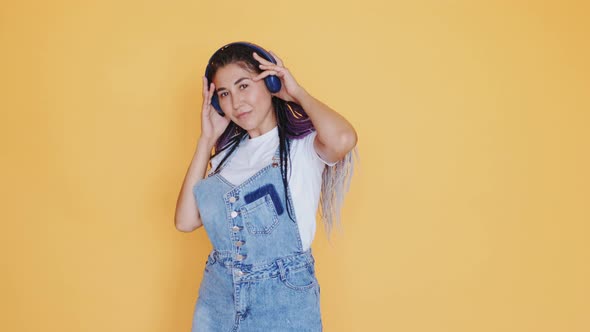 Happy Multiracial Young Woman Smiling Standing and Enjoying Music in Headphones