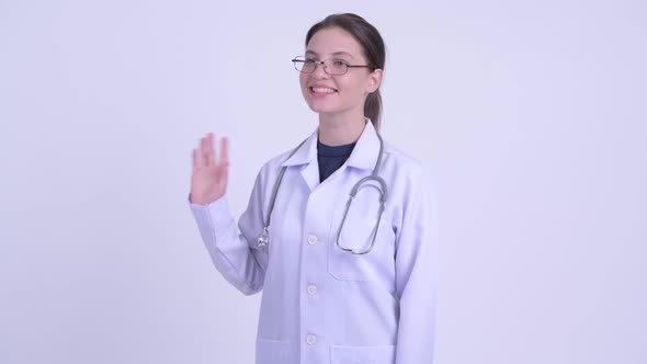 Happy Young Beautiful Woman Doctor Waving Hand