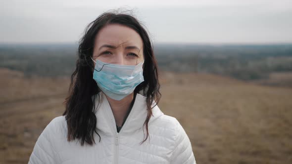 Girl with Medical Mask To Protect Her From Virus. Pandemic Coronavirus Concept