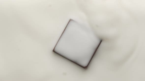 Square Chocolate Falling Into Melt Yogurt and Making Crown and Circular Ripples