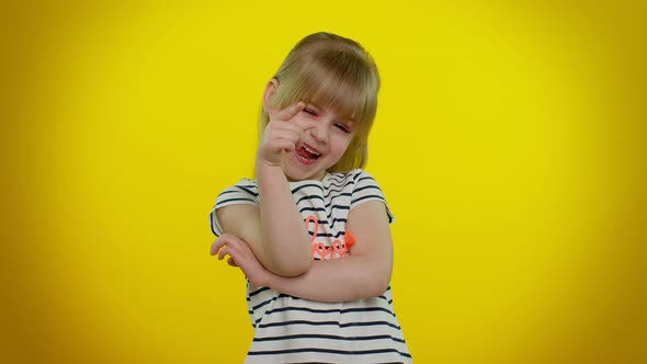 Smiling Pretty Little Blonde Teen Child Kid Girl Posing Isolated on Yellow Studio Background