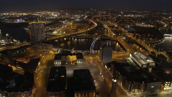 Aerial flyover of Belfast City Centre and Lagan River at night