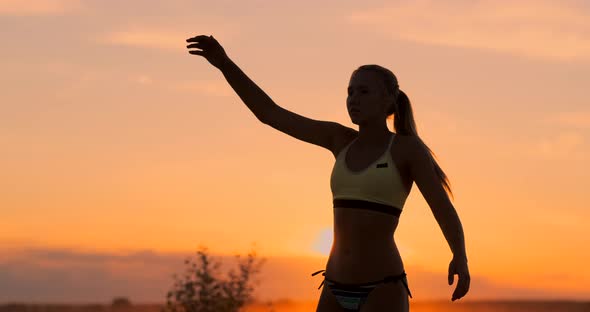 Beach Volleyball Match Girls Hit the Ball in Slow Motion at Sunset on the Sand.