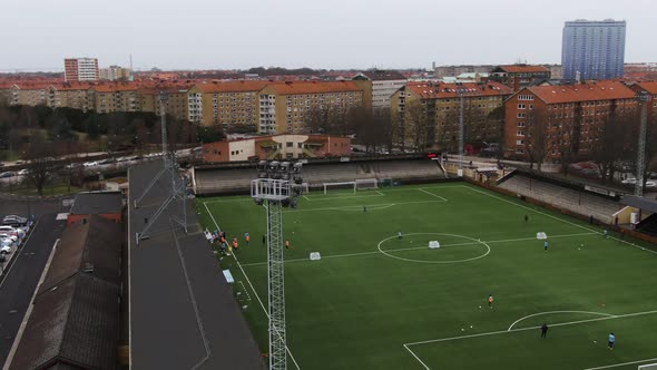 People training on Malmo soccer field, Sweden. Aerial drone view