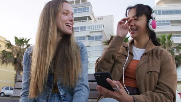 Front view of a Caucasian and a mixed race girl enjoying time outside