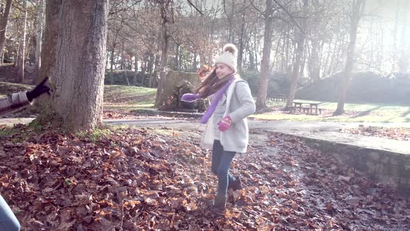 Mother and daughter get in leaf fight and throw leaves at eachother