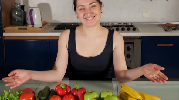 Housewife Sits and Shows Colorful Ingredients for Salad