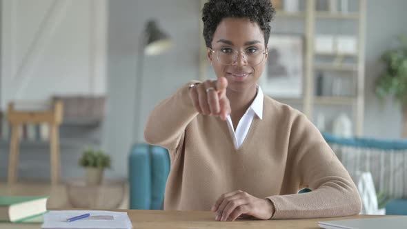 Working Young African Girl Pointing Through Finger