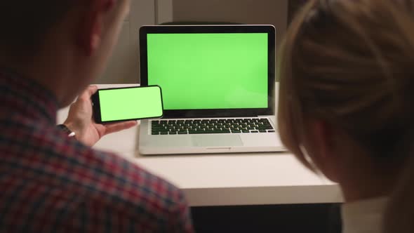 Close Up Couple Woman and Man Using Laptop and Phone Green Screen Chromakey