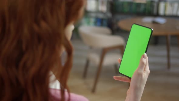 Tap to Click on Centre of Screen Back View of Woman at Home Office or Library Using Phone With Green