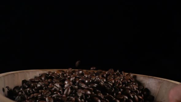 Coffee Beans Throw Up in a Wooden Bowl