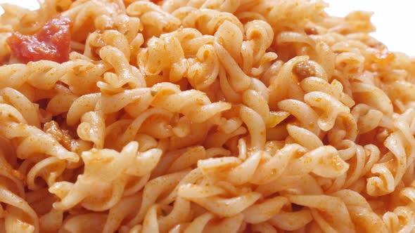 Tilting on Girandole corkscrew shaped pasta in tomato sauce prepared Italian food 4K 2160p 30fps Ult
